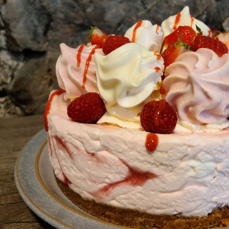 Eton Mess Cheesecake decorated with Meringues, Raspberries and Strawberries