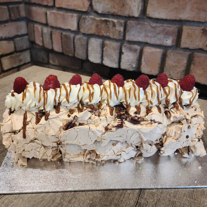 Roulade with raspberries on top against a brick wall background