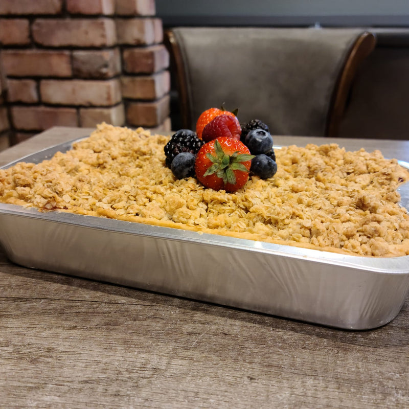 Apple and winterberry dessert with berries on a wooden table