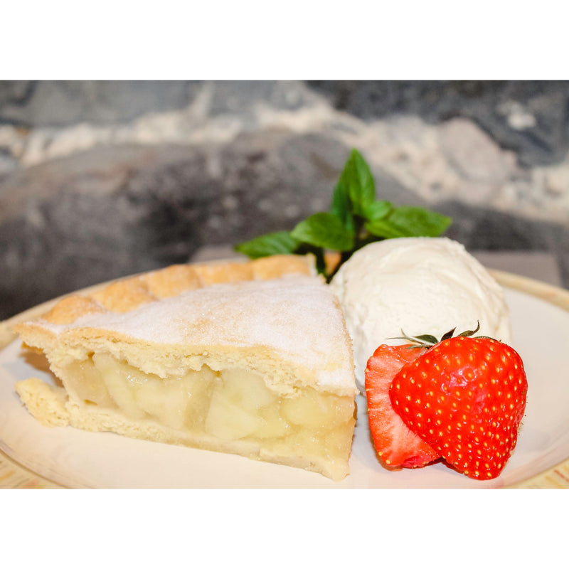 Slice of apple pie served with strawberries and ice cream