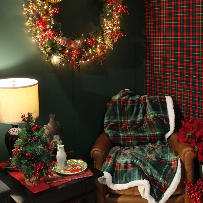 Walton and Co luxurious soft green check fabric with a snuggly sherpa reverse on leather chair. Christmas wreath scene.